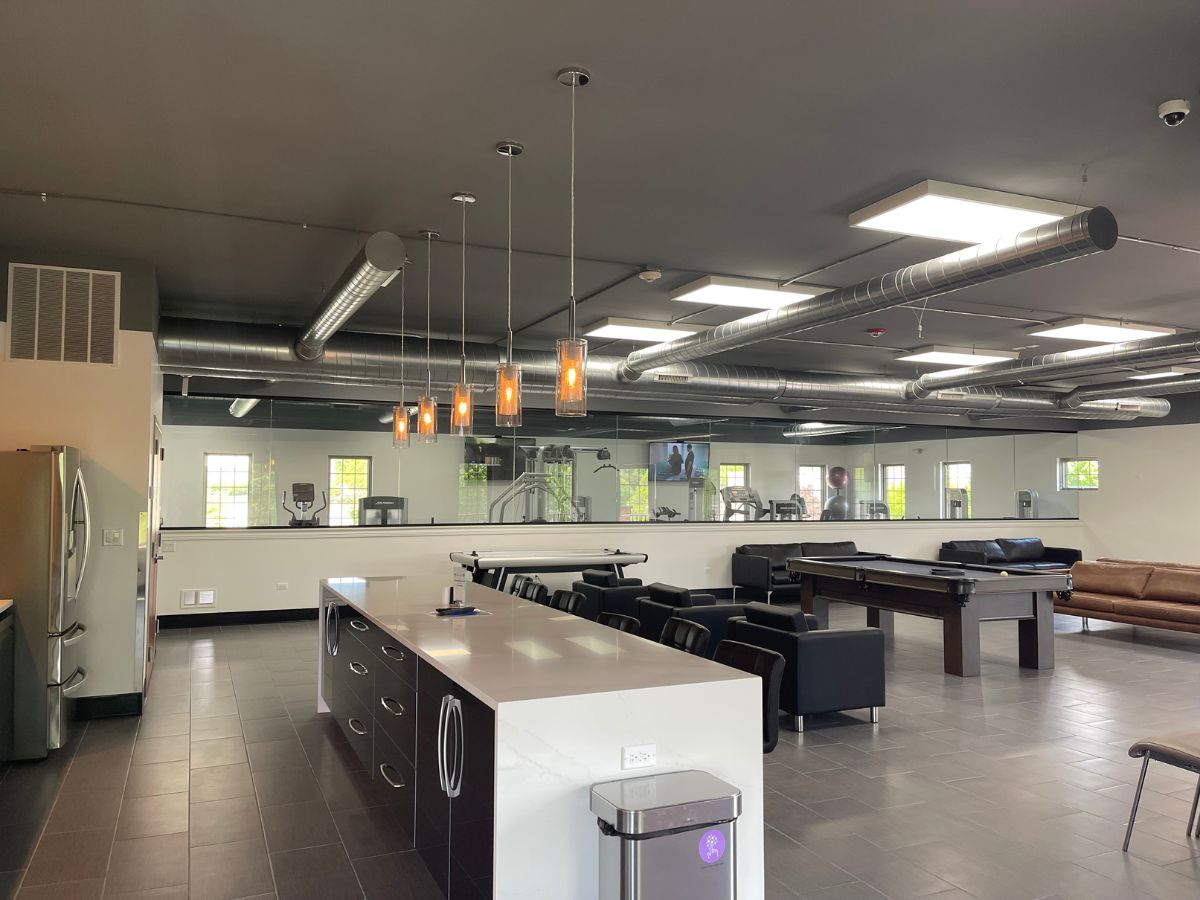 Modern lounge with kitchen and seating area.